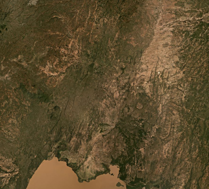 Northern Lake Abaya Volcanic Field is largely between Lake Abaya in the bottom of this image and the eroded Duguna volcano in the top center of this November 2020 Planet Labs satellite image monthly mosaic (N is at the top; this image is approximately 52 km across). The majority of the central area is recent lava flows from scoria cones with NNE-SSW-trending faults throughout. Hyaloclastite deposits are just north of this image and the 1.8-km-wide crater NNE of the lake is Chiracha volcano. Satellite image courtesy of Planet Labs Inc., 2020 (https://www.planet.com/).