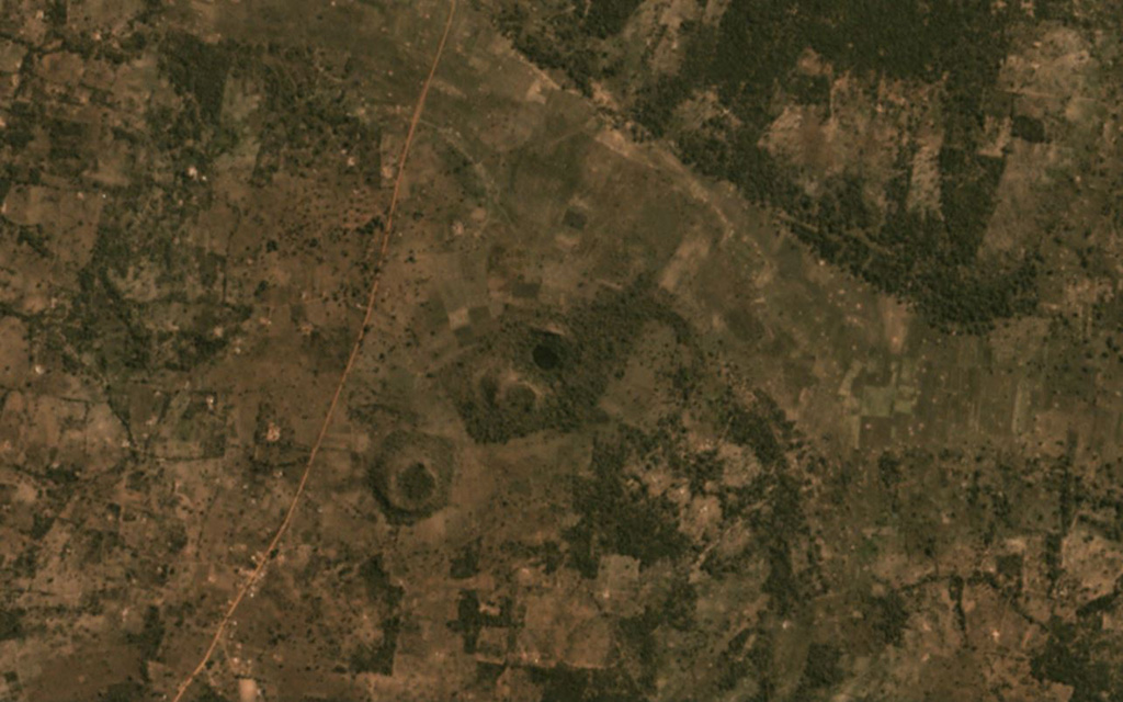 The Igwisi Hills volcanic complex contains the three kimberlite cones in the center of this November 2019 Planet Labs satellite image monthly mosaic (N is at the top; this image is approximately 3.5 km across). From the NE to SW, the three cones are NE Volcano, Central Volcano, and SW Volcano. Each cone produced viscous lavas that reached short distances from the vents. Satellite image courtesy of Planet Labs Inc., 2020 (https://www.planet.com/).