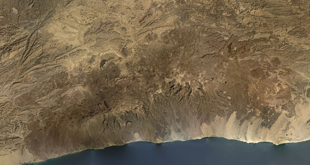 The Harra es-Sawâd (or Shuqra) volcanic field covers an area nearly 100 km across the Southern Yemen along the Gulf of Aden, shown in this December 2019 Planet Labs satellite image monthly mosaic (N is at the top; this image is approximately 104 km across). There are around 100 identified cones, and a lava field that covers an area of 40 x 95 km. Satellite image courtesy of Planet Labs Inc., 2019 (https://www.planet.com/).