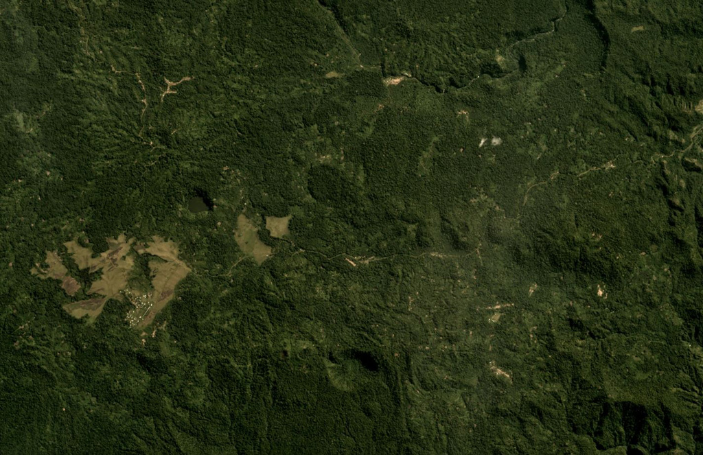 Thirty small volcanic centers have been identified in the Managlase Plateau in SE Papua New Guinea. Some of these are shown in this July 2019 Planet Labs satellite image monthly mosaic (N is at the top; this image is approximately 13 km across). Several vegetated craters, lava domes, and cones are visible across this image, and lava flows have also been reported. Satellite image courtesy of Planet Labs Inc., 2019 (https://www.planet.com/).