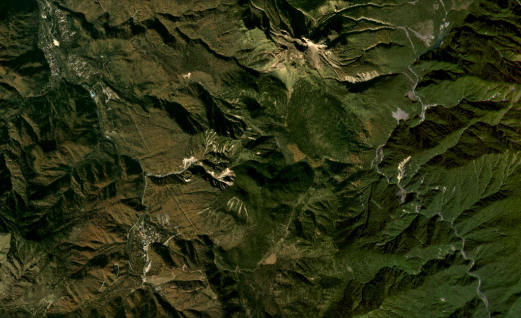 Yakedake volcano is the lava dome complex to the north (with the unvegetated summit), and Akandanayama volcano is in the center of this October 2019 Planet Labs satellite image monthly mosaic (N is at the top; this image is approximately 11 km across). It is composed of lava flows, pyroclastic deposits, and a lava dome forms the summit. Satellite image courtesy of Planet Labs Inc., 2019 (https://www.planet.com/).
