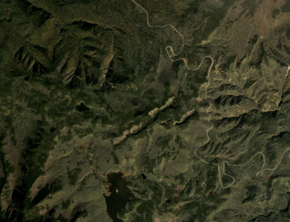 The Tenchozan volcano is in the center of this September 2019 Planet Labs satellite image monthly mosaic (N is at the top; this image is approximately 6 km across). There are two crater chains along the summit area, the 1.8-km-long northern chain consisting of ten craters, and the 700-m-long southern chain consisting of four craters. The individual crater diameters are up to 250 m (northern chain) and 100 m (southern chain), and reach up to 70 and 30 m deep, respectively. Satellite image courtesy of Planet Labs Inc., 2019 (https://www.planet.com/).