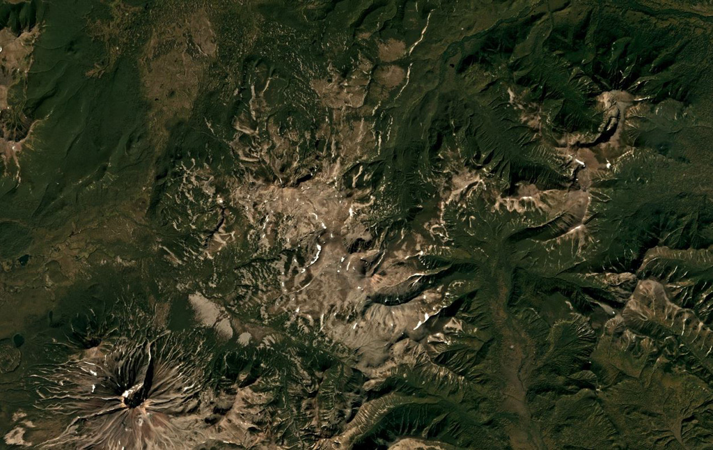 Piratkovsky in southern Kamchatka is just below the center of this September 2018 Planet Labs satellite image monthly mosaic (N is at the top; this image is approximately 30 km across). The northern part of the unvegetated area in the center is Perevalny, and the volcano with a summit crater to the SW is Khodutka. Satellite image courtesy of Planet Labs Inc., 2018 (https://www.planet.com/).