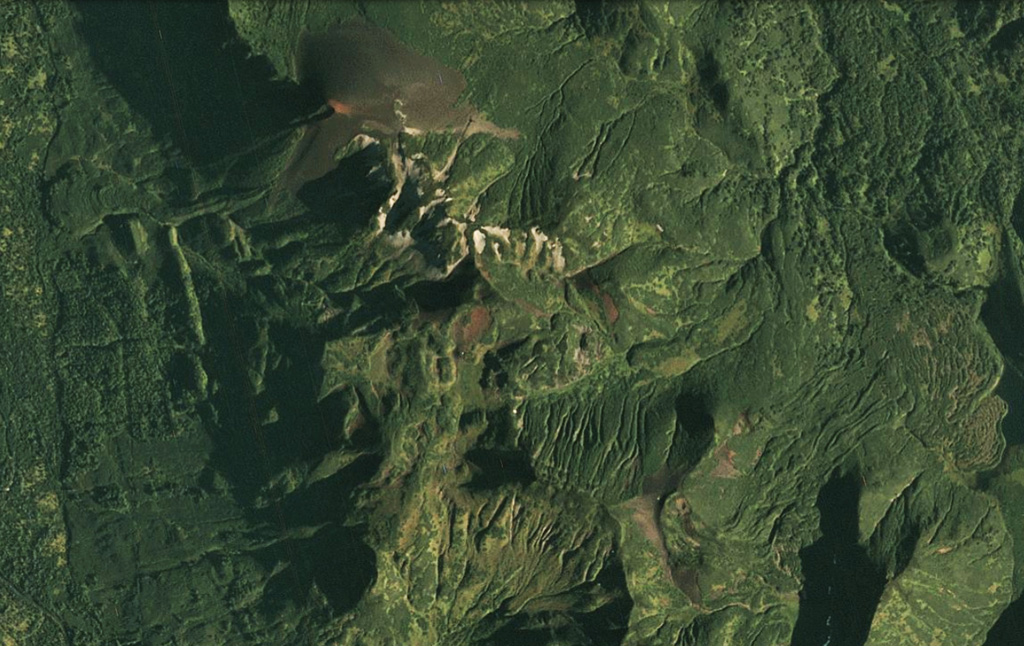 The Barkhatnaya Sopka complex is down the center of this 30 August 2020 PlanetScope satellite image (N is at the top; this image is approximately 6.5 km across). The unvegetated cone in the N is Mt. Barkhatnaya with a lava flow to the SW, and the red exposed area on the SE end of that roughly 2-km long ridge is a scoria cone on the other side of white eroded rhyolite. Barkhatnaya Sopka is a ESE-WNW-trending ridge approximately 500-m-long near the lower center of this image. Immediately E of that is the Goryachaya Sopka with a small crater that produced the lava flows towards the E. Satellite image courtesy of Planet Labs Inc., 2020 (https://www.planet.com/).