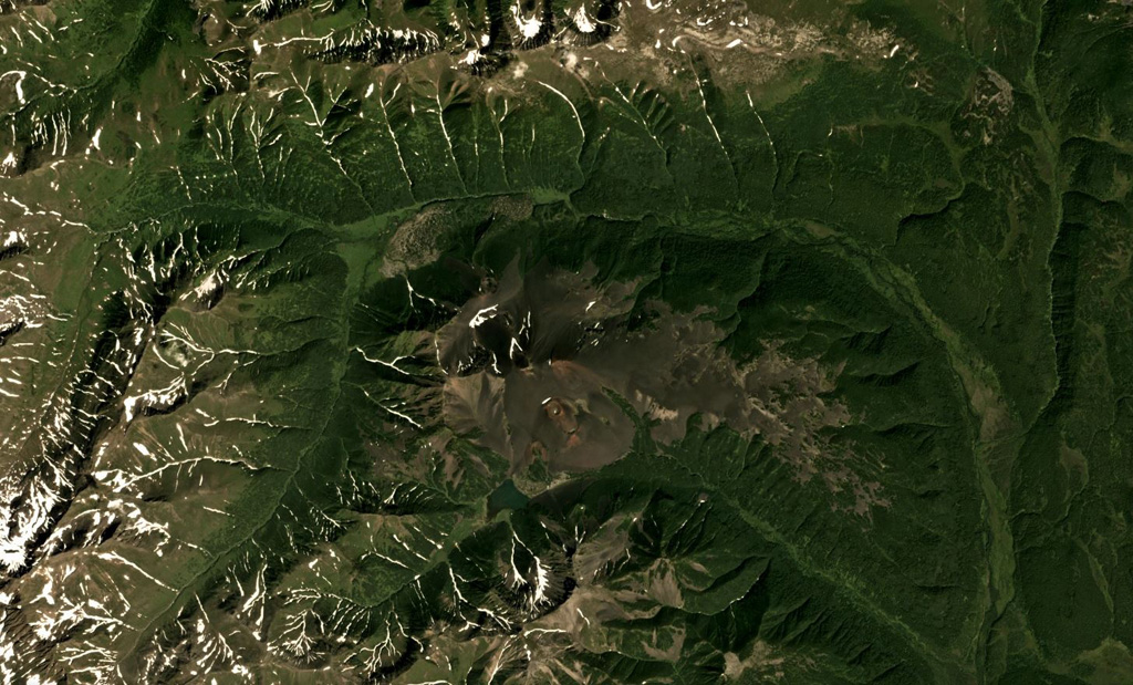 Zavaritsky is the group of six scoria cones in the center of this August 2018 Planet Labs satellite image monthly mosaic (N is at the top; this image is approximately 17 km across). The highest cone is Mount Peschanaya towards the south. The crater of one of the cones is visible on the SE flank. Satellite image courtesy of Planet Labs Inc., 2018 (https://www.planet.com/).