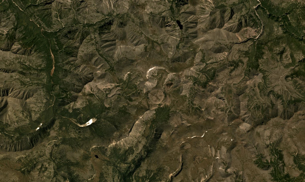 The Udokan Plateau volcanic field extends across 3,000 km2 around 400 km ENE of the northern tip of Lake Baikal, with a small part of the field that contains Holocene features shown in this July 2019 Planet Labs satellite image monthly mosaic (N is at the top; this image is approximately 16.5 km across). The round, 950-m-diameter lava dome in the center of this image is just SW of the Aku crater. Chepe cone is in the NW corner, and between them is Dolinnyi cone. Satellite image courtesy of Planet Labs Inc., 2019 (https://www.planet.com/).