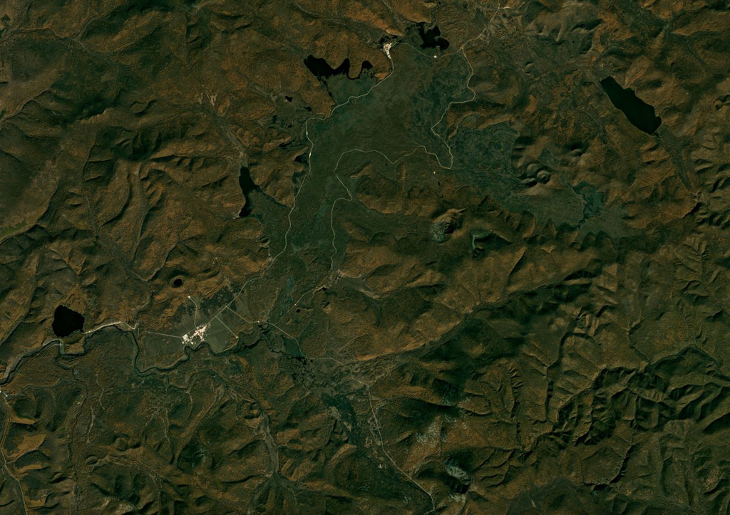 A portion of the Arxan-Chaihe volcanic field spanning approximately 32 km across is shown in this September 2018 Planet Labs satellite image monthly mosaic (N is at the top; this image is approximately 32 km across). There is a NE-SW trend of scoria cones, craters, and maars across the image, including Aershan just north of Tianchizhen town (in the western side of the image), the smaller Dichi lake to the E, the larger Shihaopendi complex crater near the center of this image, and Yanshan and Gaoshan NE of there. Satellite image courtesy of Planet Labs Inc., 2018 (https://www.planet.com/).