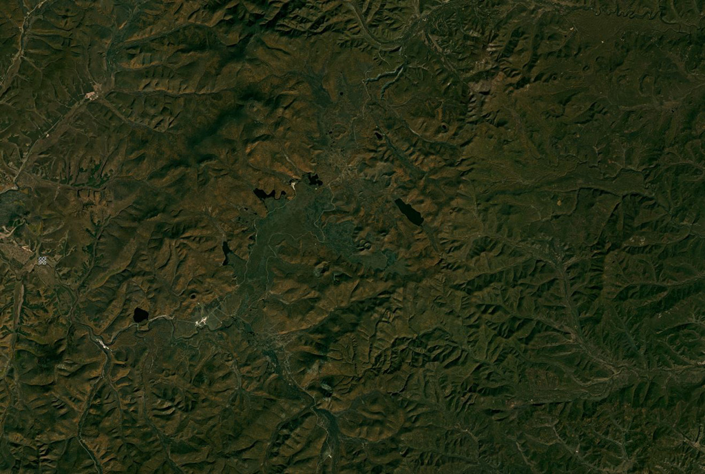 The Arxan-Chaihe volcanic field covers around 2,000 km2 with at least 47 identified vents, some of which can be seen in a NE-SW trend through the center of this September 2019 Planet Labs satellite image monthly mosaic (N is at the top; this image is approximately 69 km across). As well as eruptions producing spatter cones and lava flows, there are phreatomagmatic vents and fissure-controlled vents. Satellite image courtesy of Planet Labs Inc., 2018 (https://www.planet.com/).