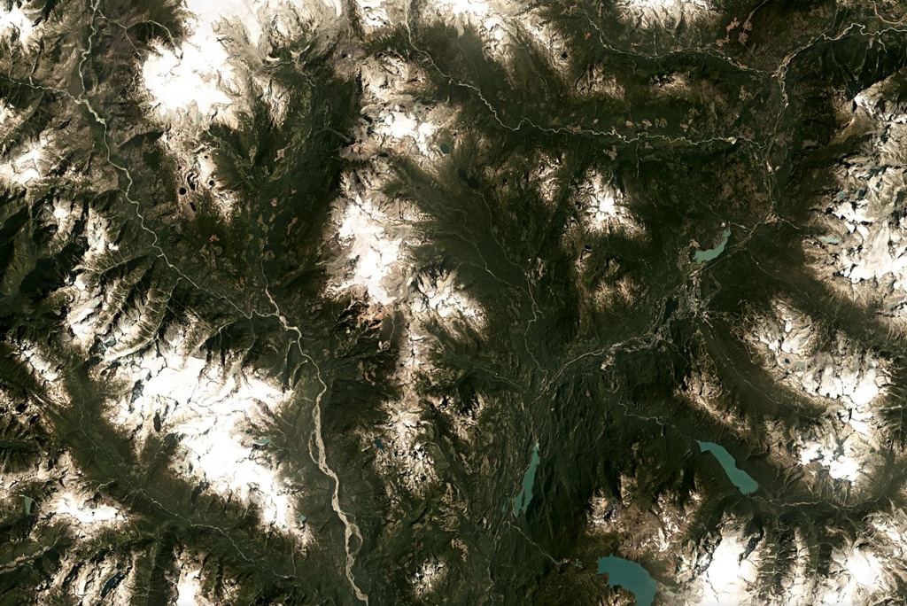 The heavily eroded Cayley Volcanic Field in SW Canada is the N-S trending ridge down the center of this August 2019 Planet Labs satellite image monthly mosaic (N is at the top; this image is approximately 69 km across). The complex is composed of different eruption centers including lava domes, cones, and glaciovolcanic features, and has also been shaped by large flank collapse events. Satellite image courtesy of Planet Labs Inc., 2019 (https://www.planet.com/).