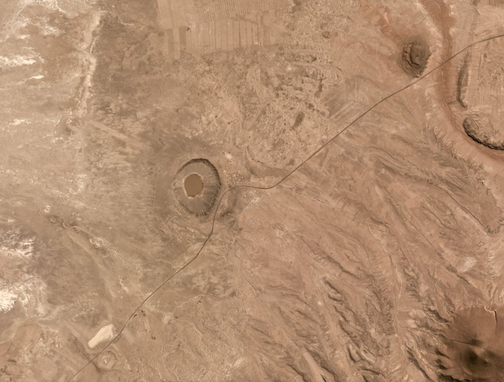 The two maars of the Laguna Jayu Khota group in Bolivia are shown in this June 2019 Planet Labs satellite image monthly mosaic (N is at the top; this image is approximately 10 km across). The Laguna Jayu Khota maar is near the center of the image and the Nehke Khota maar is on the southern side of the road near the lower left corner. Satellite image courtesy of Planet Labs Inc., 2019 (https://www.planet.com/).