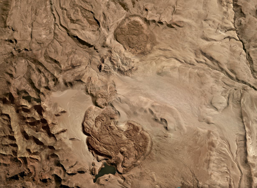 Several lava domes and flows or coulees of the Jatun Mundo Quri Warani complex (also known as Nuevo Mundo) in Bolivia are shown in this July 2019 Planet Labs satellite image monthly mosaic (N is at the top; this image is approximately 23 km across). Satellite image courtesy of Planet Labs Inc., 2019 (https://www.planet.com/).