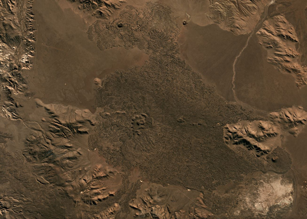 The Crater Basalt Volcanic Field in Argentina covers around 700 km2, with a portion of the field shown in this July 2019 Planet Labs satellite image monthly mosaic (N is at the top; this image is approximately 33 km across). There are at least nine scoria cones across the field as well as the mostly pahoehoe lava flows reaching out to 5 km. Satellite image courtesy of Planet Labs Inc., 2019 (https://www.planet.com/).