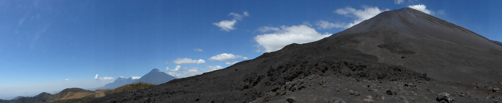 This February 2018 panorama shows the relative positions of several eastern Guatemalan volcanoes. From left to right are Fuego, Acatenango, Agua, and Pacaya. Photo by Ailsa Naismith, 2018.