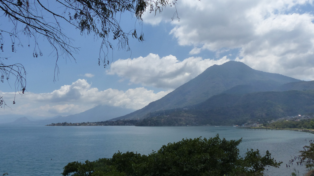 This 2018 view of Volcán San Pedro of Guatemala is from the W near San Juan La Laguna, with Volcán Tolimán volcano behind it. These cones along with the active Atitlán cone behind them have formed along the rim of the Atitlán III caldera, with the lake in the foreground filling the northern area.   Photo by Ailsa Naismith, 2018.