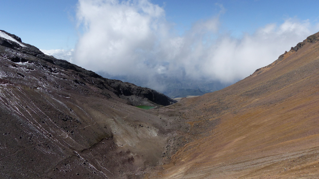 A small lake is seen here between the two peaks of Illiniza, with the flank of Illiniza Norte to the right and Illiniza Sur to the left. Photo by Ailsa Naismith, 2015.