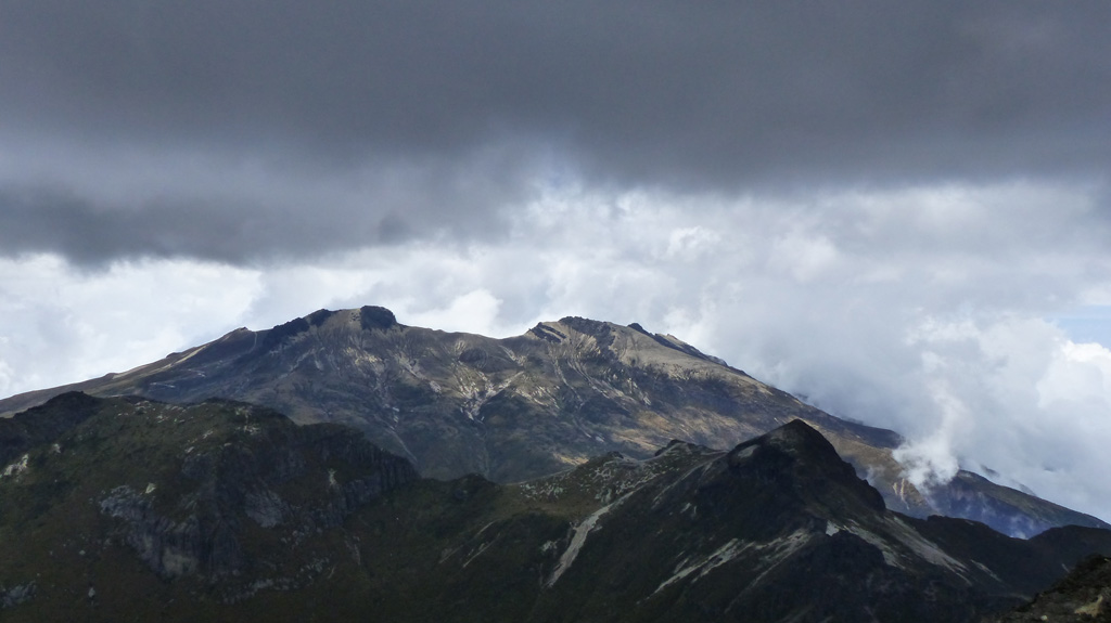 This October 2015 view is from the summit of Rucu Pichincha (“Old Man Pichincha” in the indigenous Quechua language) facing west towards the Guagua Pichincha (“Baby Pichincha”) vent. Eruptions have produced ashfall that has impacted Quito, 14 km W. The recently active vent is situated within a landslide scarp that opens towards the SW, and an older landslide scarp is on the western flank. Photo by Ailsa Naismith, 2015.