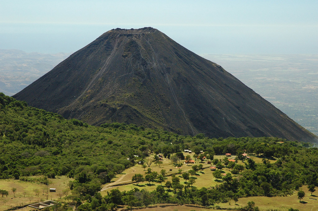 Izalco is seen here looking S from the summit of Santa Ana in 2011. The forested flank of Cerro Verde, a cone of Santa Ana, is visible on the left. Photo by Lis Gallant, 2011.