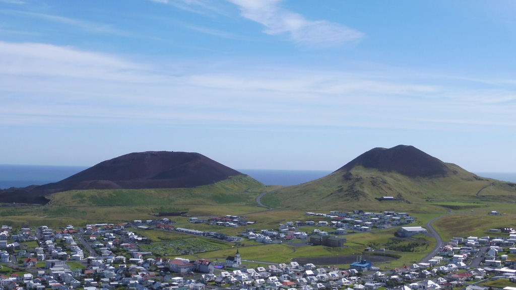 Vestmannaeyjar is a volcanic field about 20-25 km wide by 30-35 km long that forms an archipelago off the south coast of Iceland, about 60 km W of the town of Vik. The Eldfell (left) and Helgafell (right) scoria cones are seen here from the northern tip of Heimaey island in July 2019. Eldfell formed in 1973 and Helgafell around 5,900 BP. Photo by Arianna Soldati, 2019.