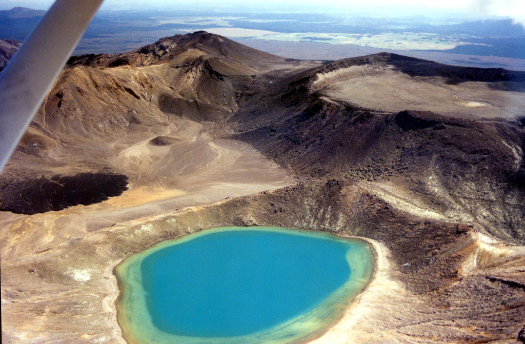 The Blue Lake vent of the Tongariro volcanic complex is in the foreground of this 1995-96 photo, looking SW. The roughly 1-km-wide North Crater is to the right and to the left is a post-1.85 ka lava flow from Red Crater that was emplaced into Central Crater (not of eruption origin). Photo by John A Krippner, 1995-1996.