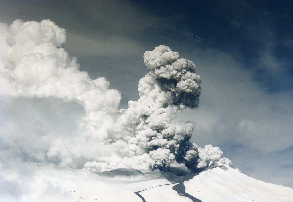 A gas-and-steam plume rises above the Ruapehu Te Wai a-Moe (Crater Lake) during Surtseyan activity in September 1995 with two lahar deposits down the Whakapapa ski field on the northern flank. By early October almost all of the crater lake water had been removed. Photo by John A Krippner, 1995.