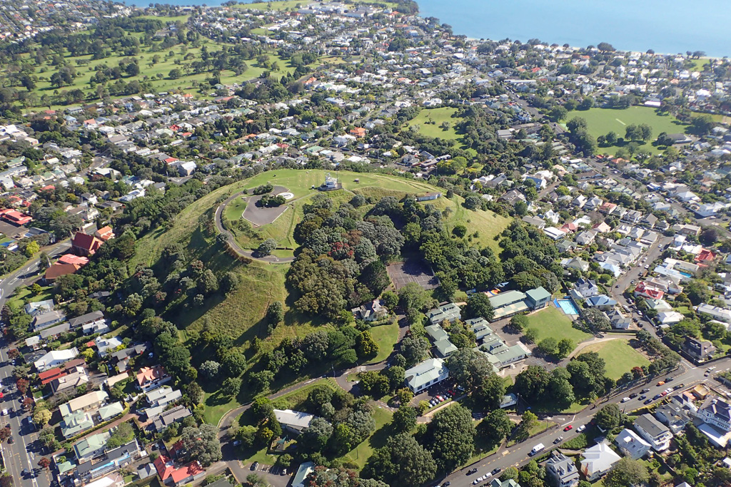 Mount Victoria or Takarunga is a scoria cone with a horseshoe-shaped crater in the Auckland Volcanic Field, seen here in 2018 from the north with the Waitematā Harbour at the top of the photo. Photo by Bruce Hayward, 2018.