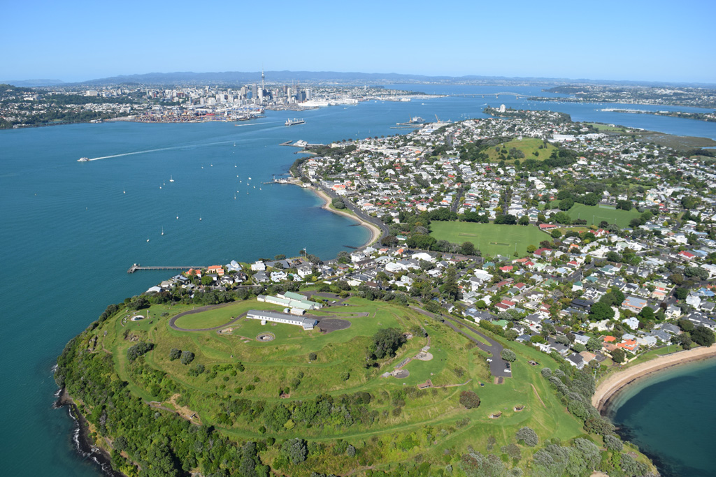 North Head or Maungauika is a scoria cone and tuff ring that formed in the Auckland Volcanic Field around 87 ka. This 2018 view from the east shows the Mount Victoria or Takarunga scoria cone to the upper right and the Auckland city center to the upper left. Photo by Bruce Hayward, 2018.