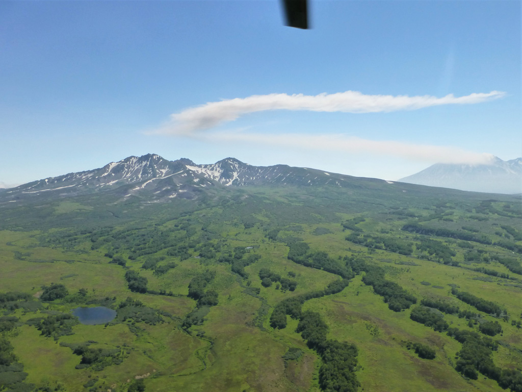 The Pleistocene Zhupanovskiye Vostriyaky is shown here from the N with Zhupanovsky in the background to the right on. A gas plume is emanating from the Priemysh cone and is being dispersed N then W.  Photo by Janine Krippner, 2014.