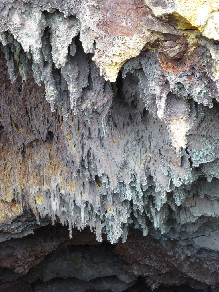 Once the lava began to drain from a 2012-13 Tolbachik lava tube the dripping lava formed these structures on the ceiling, with minerals forming across the surfaces. Photo by Janine Krippner, 2015.