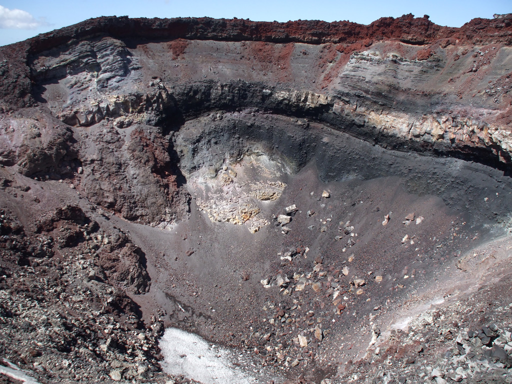 The crater of the Ngauruhoe scoria cone is seen here from the NW rim on 8 February 2008. The cone formed mainly through a series of Strombolian and Vulcanian eruptions in 1954-55, with the red uppermost scoria unit emplaced in 1974-75. Photo by Janine Krippner, 2008.