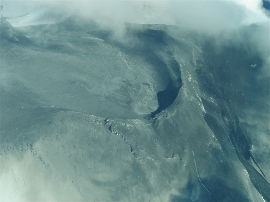 Surtseyan deposits from the 25 September 2007 Ruapehu eruption are seen here across Central Crater and the northern flank. In the lower part of the image is the ballistic apron, where blocks up to 2 m in diameter landed more than 2 km from their source. The northern flank lahar is to the lower right. Photo by Janine Krippner, 2007.