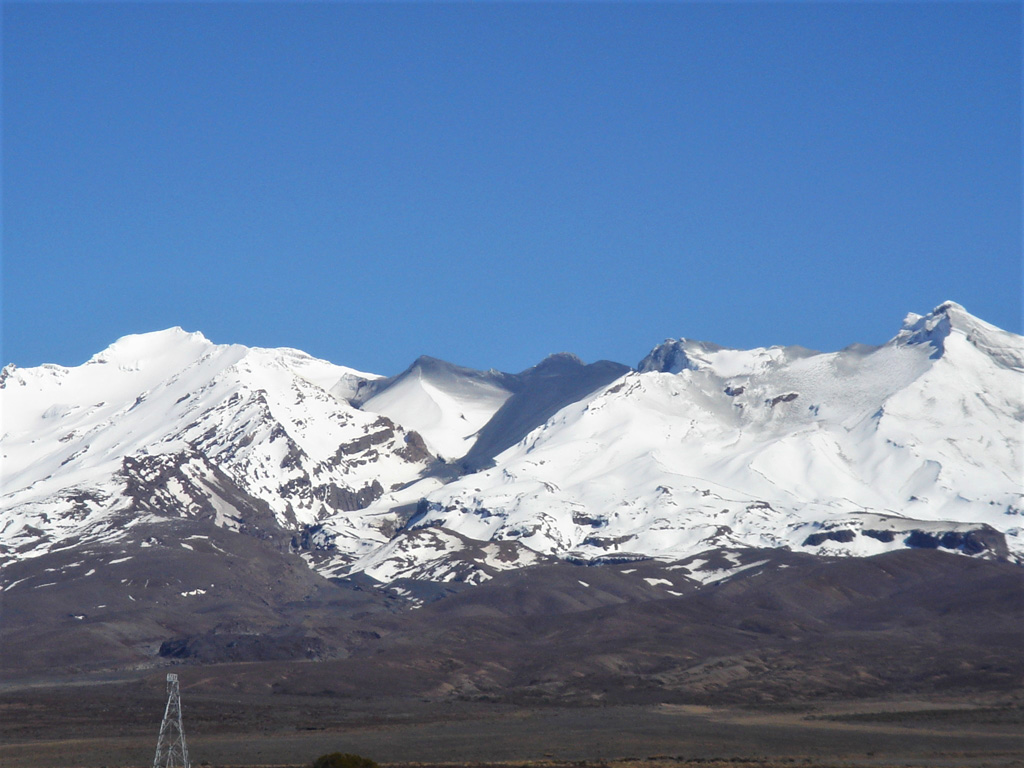 The 25 September 2007 Ruapehu lahar that travelled down the Whangaehu Valley is seen here from the E two days later. The black deposit in the center includes two lahar descent paths that merged, and ash and mud deposits from the explosion that occurred within Crater Lake. Photo by Janine Krippner, 2007.