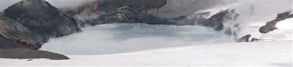 The Ruapehu Crater Lake is seen here on 4 March 2007 from the N, looking towards the tephra dam that failed on the 18th, resulting in 11% of the water draining through lahars down the Whangaehu valley on the E flank and down the N flank. The water temperatures fluctuate through time with geothermal activity below the lake. Photo by Janine Krippner, 2007.